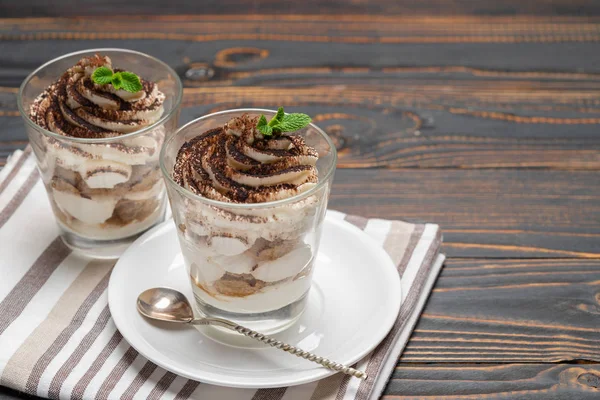 Stock image Classic tiramisu dessert in a glass on wooden background