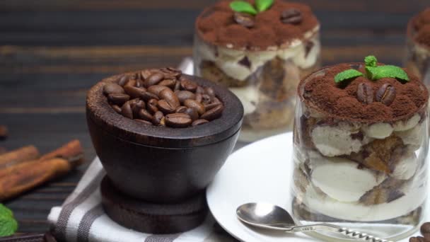 Classic tiramisu dessert in a glass on wooden background — Stock Video