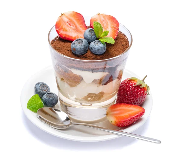 Классический десерт из тирамису с черникой и клубникой в стакане, изолированном на белом фоне с вырезанной дорожкой — стоковое фото