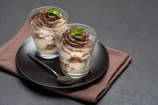 Postre tiramisú clásico en un vaso sobre fondo de hormigón oscuro —  Fotos de Stock