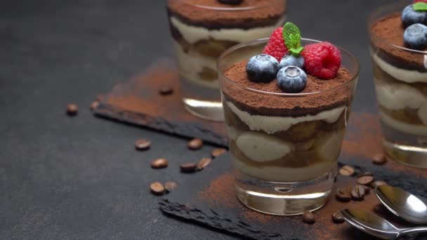 Classic tiramisu dessert with blueberries and raspberries in a glass on stone serving board — Stock Video