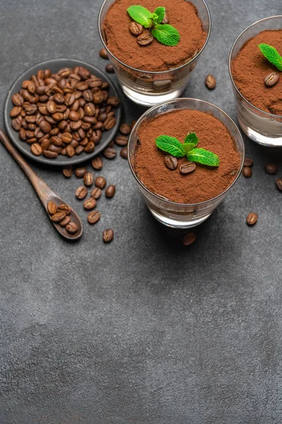 Classic tiramisu dessert in a glass on dark concrete background — Stock Photo, Image