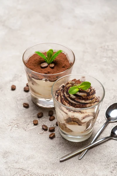 Classic tiramisu dessert in a glass cup on concrete background — Stock Photo, Image