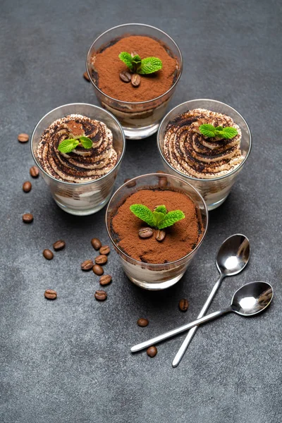 Classic tiramisu dessert in a glass cup on dark concrete background — Stock Photo, Image