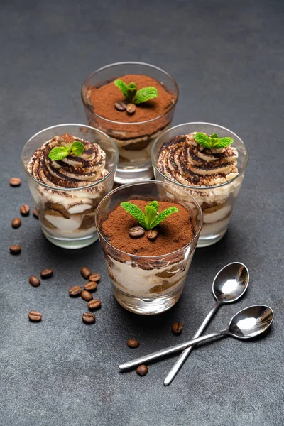 Classic tiramisu dessert in a glass cup on dark concrete background — Stock Photo, Image