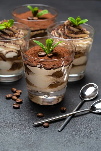 Postre tiramisú clásico en una taza de vidrio sobre fondo de hormigón oscuro —  Fotos de Stock