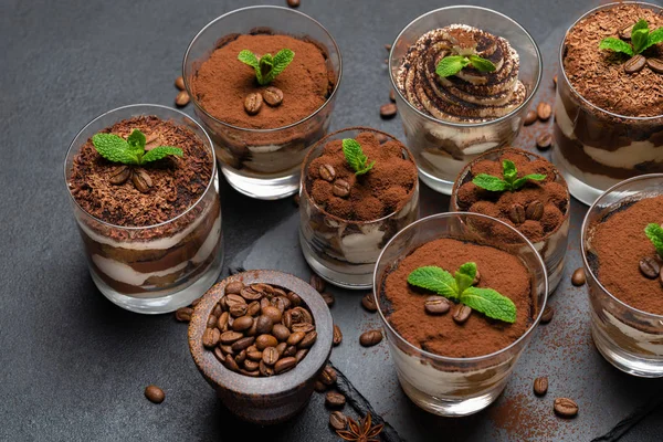 Group of portions of Classic tiramisu dessert in a glass cup on stone board on concrete background — Stock Photo, Image