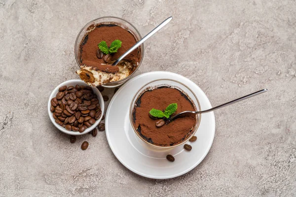 Portion of Classic tiramisu dessert in a glass cup on concrete background — Stock Photo, Image