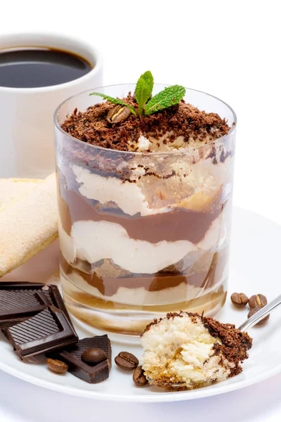 Classico dessert tiramisù in un bicchiere, tazza di caffè e pezzi di cioccolato su sfondo bianco con percorso di ritaglio — Foto Stock