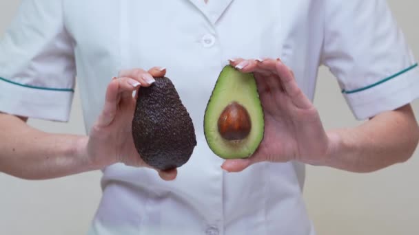 Nutritionist doctor healthy lifestyle concept - holding organic avocado — Stock Video