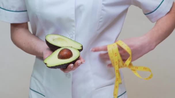 栄養士医師健康的なライフスタイルの概念-有機アボカドの果物や測定テープを保持 — ストック動画