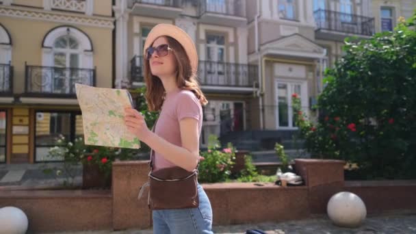 Schöne junge Touristin Angenehm mit Stadtplan und Koffer im Stadtzentrum — Stockvideo