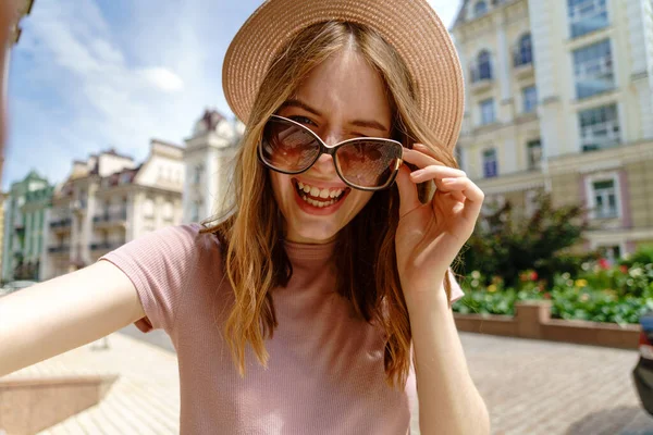 아름다운 여인이 안경을 쓰고 시내 중심가에서 셀카를 만드는 모습 — 스톡 사진
