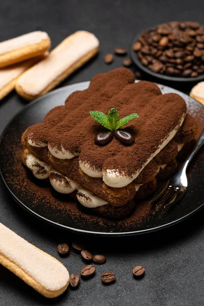 Sobremesa tiramisu clássica em placa cerâmica e biscoitos savoiardi no fundo de concreto — Fotografia de Stock