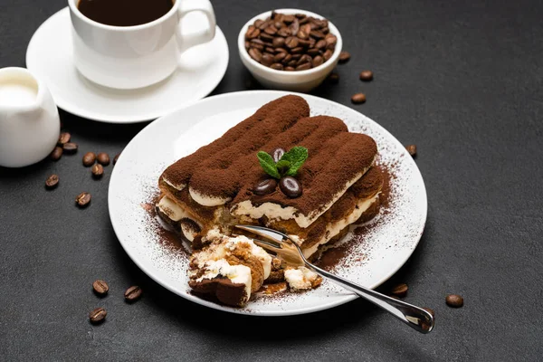 Portion of Classic tiramisu dessert and cup of fresh espresso coffee on concrete background — Stock Photo, Image