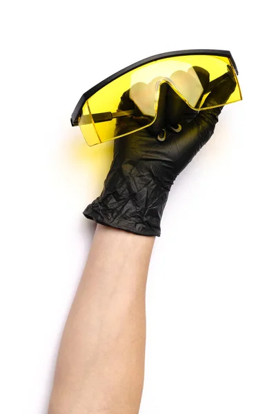 Hands with medical latex gloves holding protective goggles on white background — Stock Photo, Image