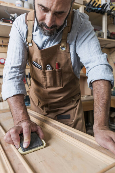 caucasian carpenter at work in a workshop
