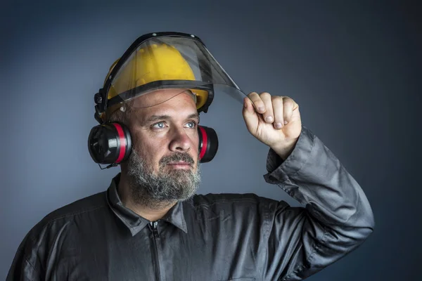 portrait of caucasian manual worker with protection clothes