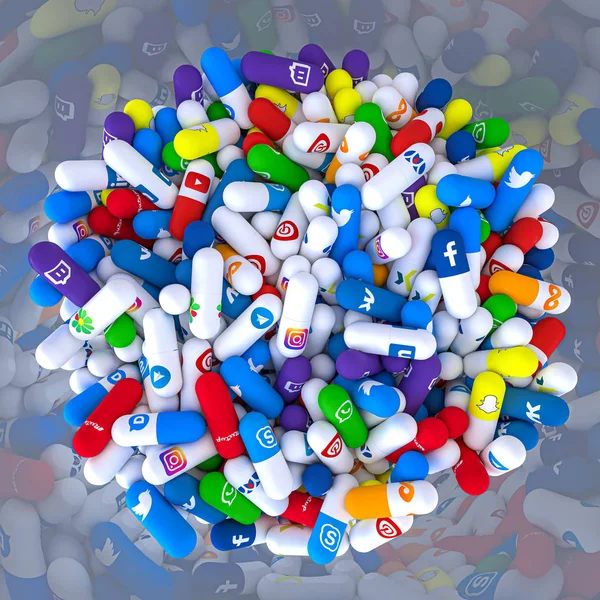Pills of various types and sizes in a bottle bearing the logo of — Stock Photo, Image