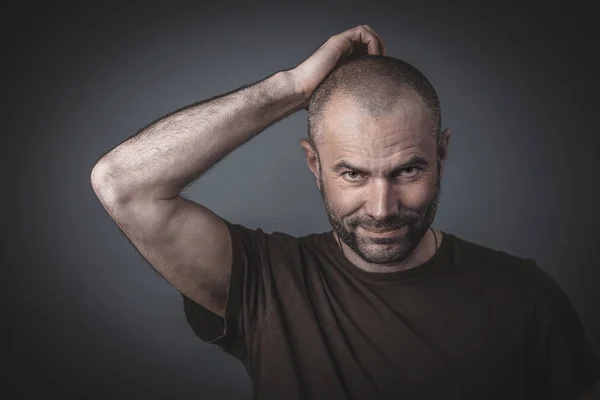 Portrait of a man scratching his head