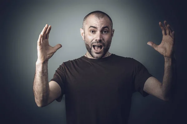 Portrait of a man with surprised expression and open arms ahead — Stock Photo, Image