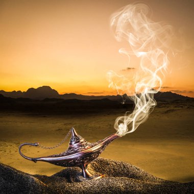 classic gold-colored aladdin lamp laid on the sand of a dune wit clipart