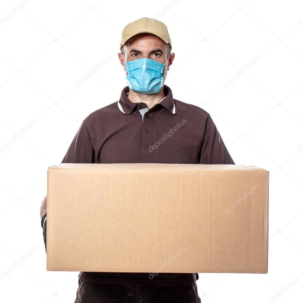 Caucasian man courier with mask and big package to be delivered. shipments during the coronavirus pandemic