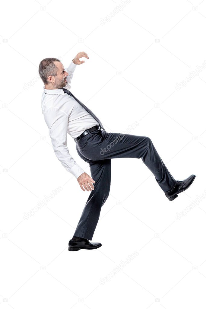 businessman losing his balance. isolated on white.