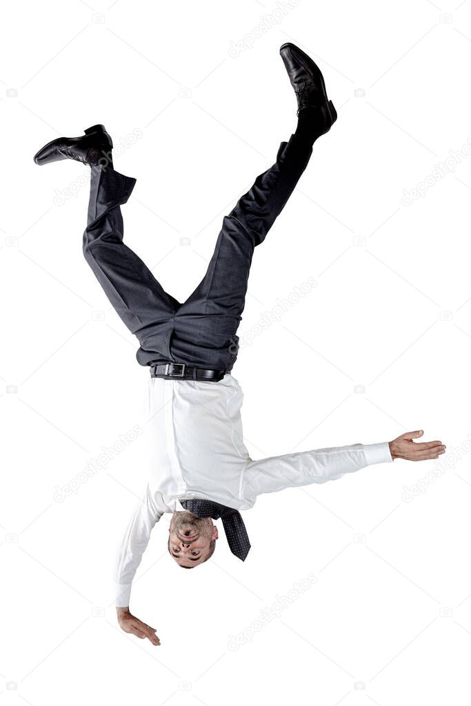 Businessman upside down balancing on one hand. isolated on white.