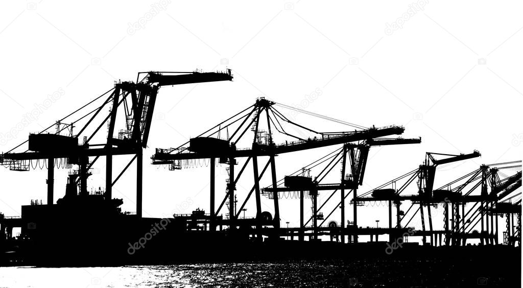 Silhouette of large cranes used for loading containers on to ships