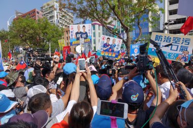 KAOHSIUNG, TAIWAN -- NOVEMBER 11, 2018: Supporters and media rush to greet KMT Kaohsiung mayor candidate Han Guo-Yun at an election event clipart