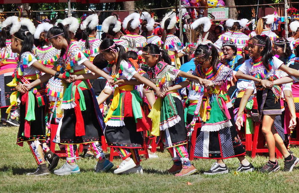 KAOHSIUNG, TAIWAN -- SEPTEMBER 29, 2018: Members of the indigenous Amis tribe in traditional costumes participate in the yearly harvest festival.