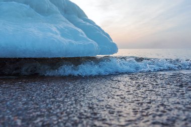 Melting ice on Baltic sea coast. clipart