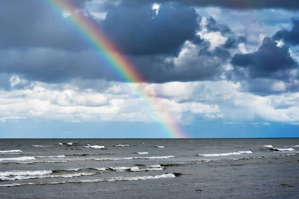 Clouds and rainbow over gulf of Riga, Baltic sea.