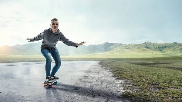 Teenager girl ride her skateboard. Mixed media — Stock Photo, Image