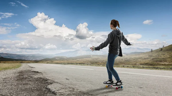 Teenager girl ride her skateboard. Mixed media — Stock Photo, Image