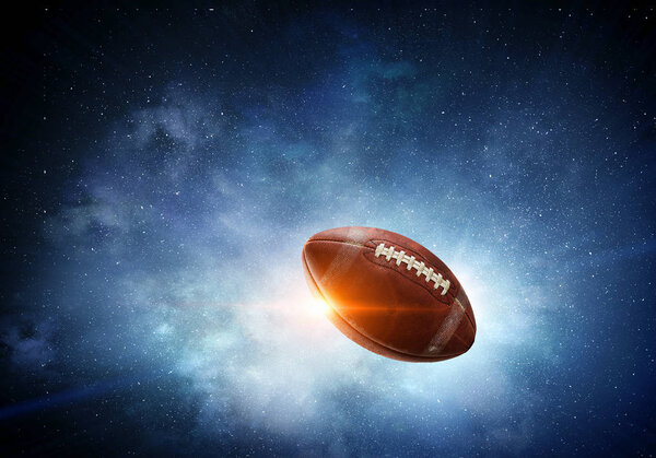 Rugby ball flying in starry space. Mixed media