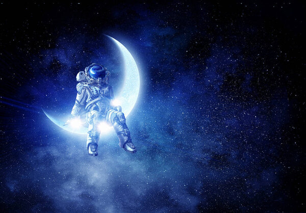 Spaceman sitting on moon against dark starry sky. Mixed media