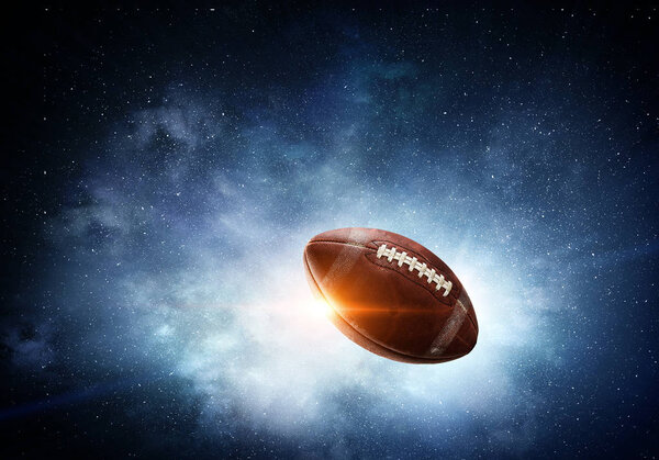 Rugby ball flying in starry space. Mixed media