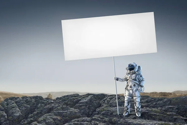 Spaceman with banner. Mixed media — Stock Photo, Image