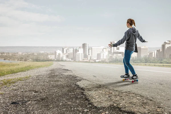 Teenager girl ride her skateboard. Mixed media — Stock Photo, Image