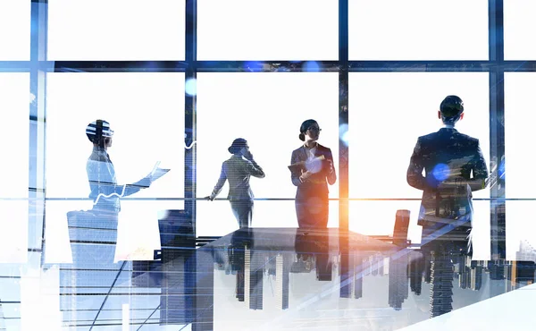 Business team in front of office window — Stock Photo, Image