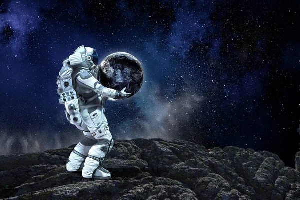 Spaceman dragen grote planeet. Mixed media — Stockfoto