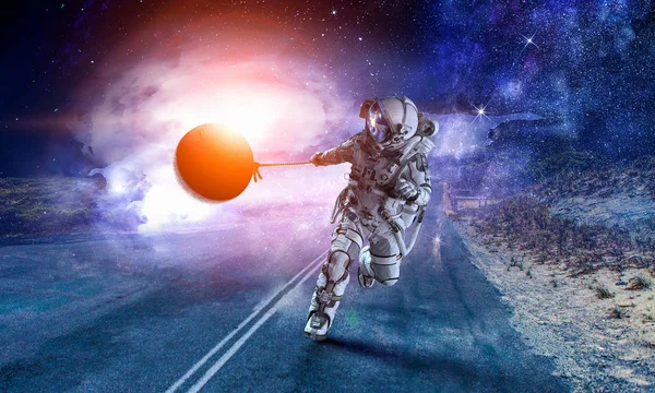 Spaceman steal planet. Mixed media — Stock Photo, Image