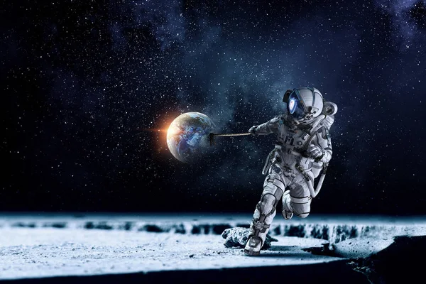 Spaceman steal planet. Mixed media — Stock Photo, Image