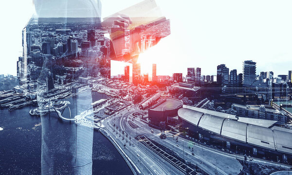 Double exposure of elegant businesswoman and modern city on white background