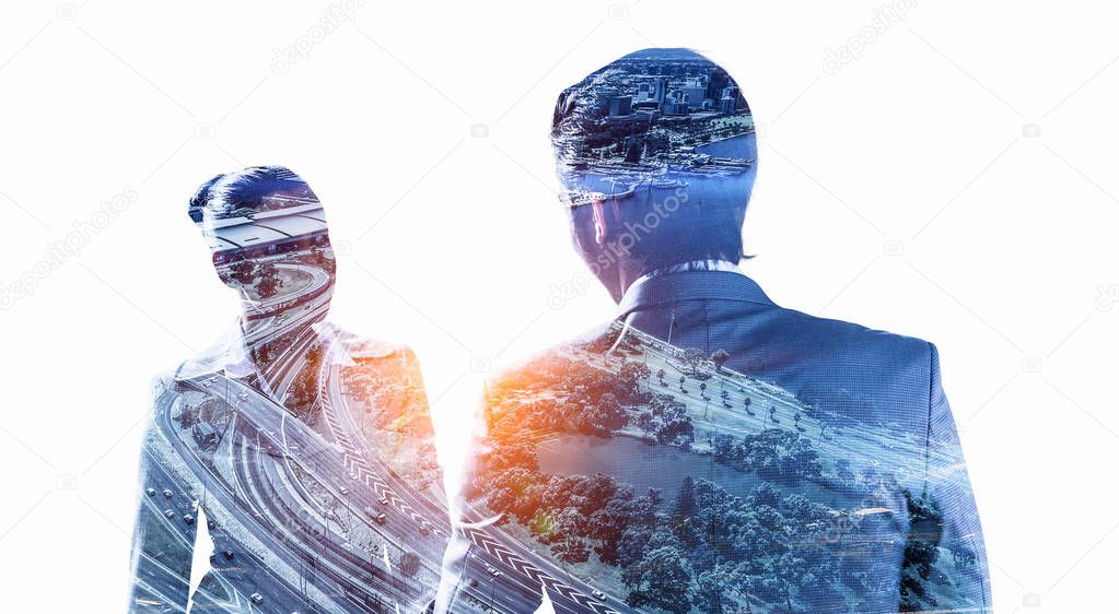 Double exposure of business people shaking hands and modern cityscape. Mixed media