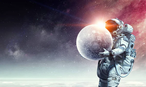 Spaceman carry moon planet. Mixed media — Stock Photo, Image