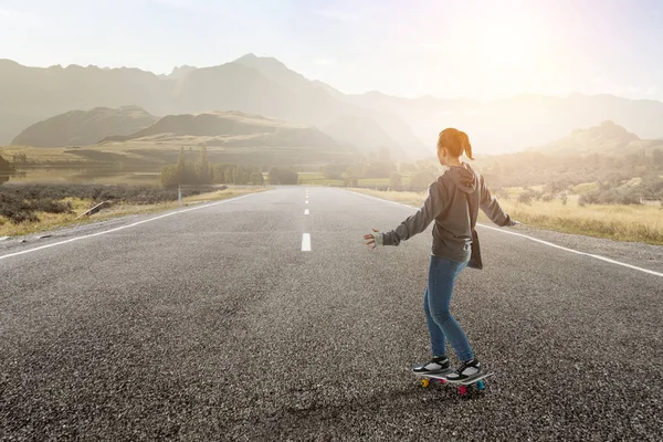 Teenager girl ride her skateboard. Mixed media — Stock Photo, Image