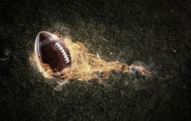 Koyu arka plan üzerinde Rugby topu bir yangında alevler. Karışık teknik